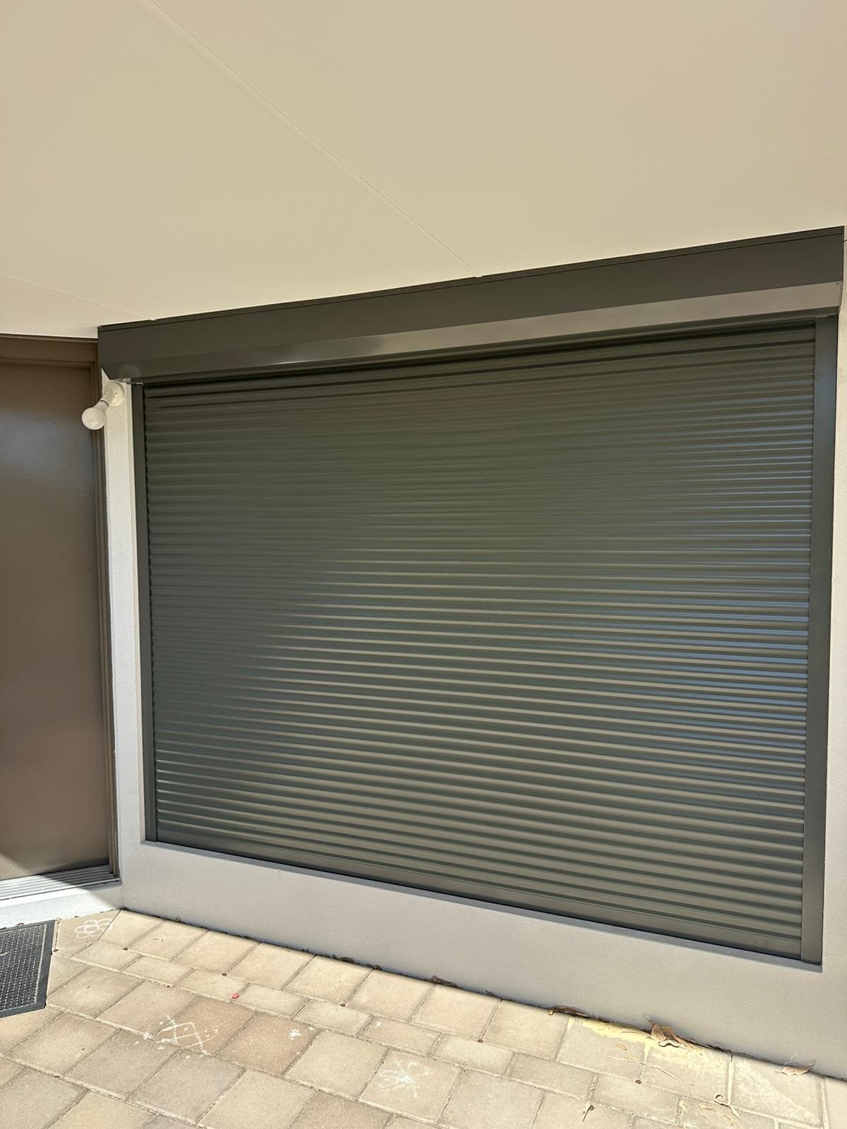 Close-up detail of dark grey roller shutter installation